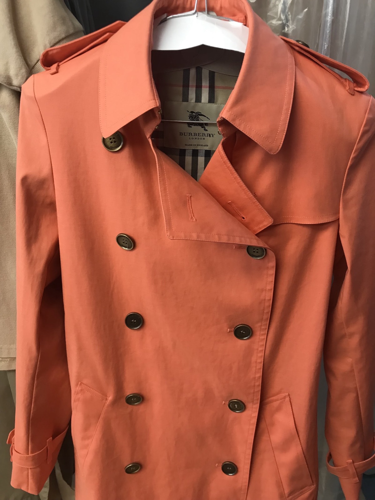 Coral cotton trench coat pressed and hung at Fresh Touch Dry Cleaners